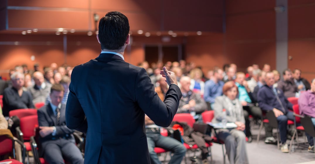 Public Speaker Giving Talk at Business Event.